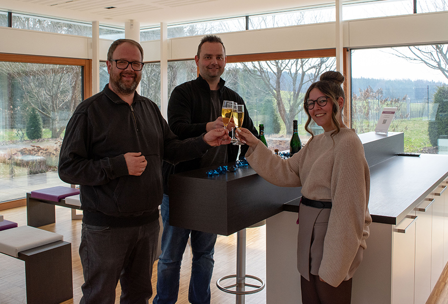 Alle stoßen mit Sekt in der Cafeteria an